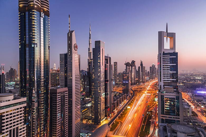 The Burj Khalifa soaring through the bright lights of downtown Dubai