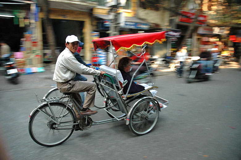 Cyclo on the streets of Hanoi, Vietnam - © <a href='https://www.flickr.com/photos/graemenewcomb/342449410/' target='new window o' rel='nofollow'>Graeme Newcomb</a> - Flickr <a href='https://creativecommons.org/licenses/by/2.0/' target='new window l' rel='nofollow'>CC BY 2.0</a>