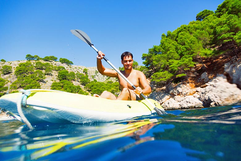 Navigate Ibiza's rocky coastline in a sea kayak