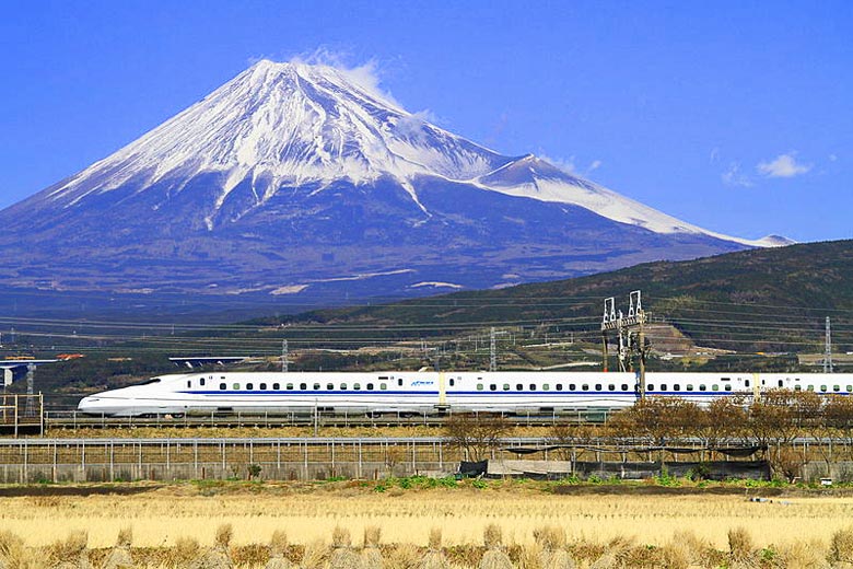 Bullet train speeding past Mount Fuji, Japan