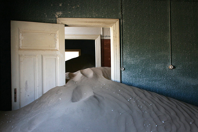 The creeping desert sands of Kolmanskop, Namibia