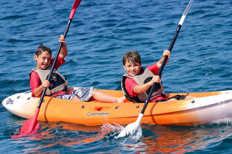 Kids kayaking at Portomyrina Palace Beachclub, Lemnos, Greece