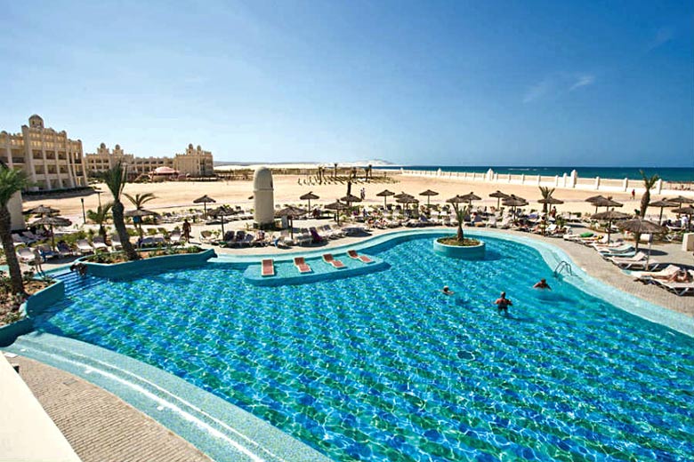 Pool beside the ocean at ClubHotel Riu Karamboa, Cape Verde Pool beside the ocean at ClubHotel Riu Karamboa, Cape Verde
